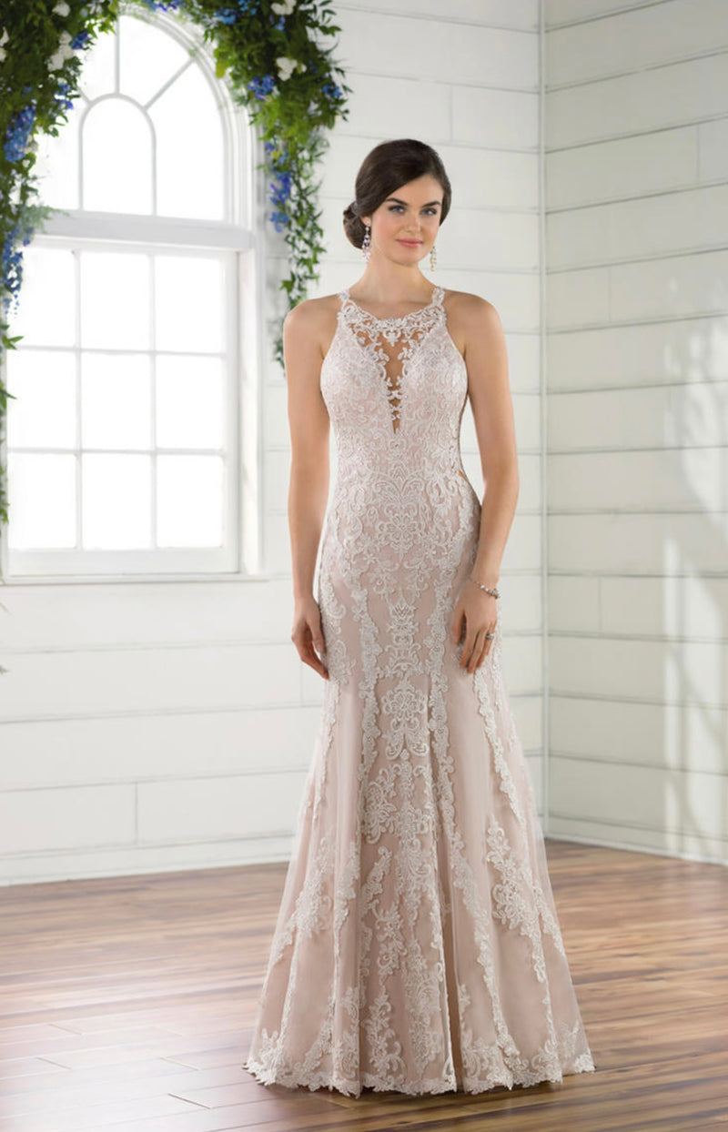 Essense of Australia D2432f featuring a high neckline, the bodice of this gown features peek-a-boo detailing with illusion tulle and a plunging sweetheart neckline. The rich lace pattern continues through the bodice and onto the tulle skirt, creating elongating, linear patterns
