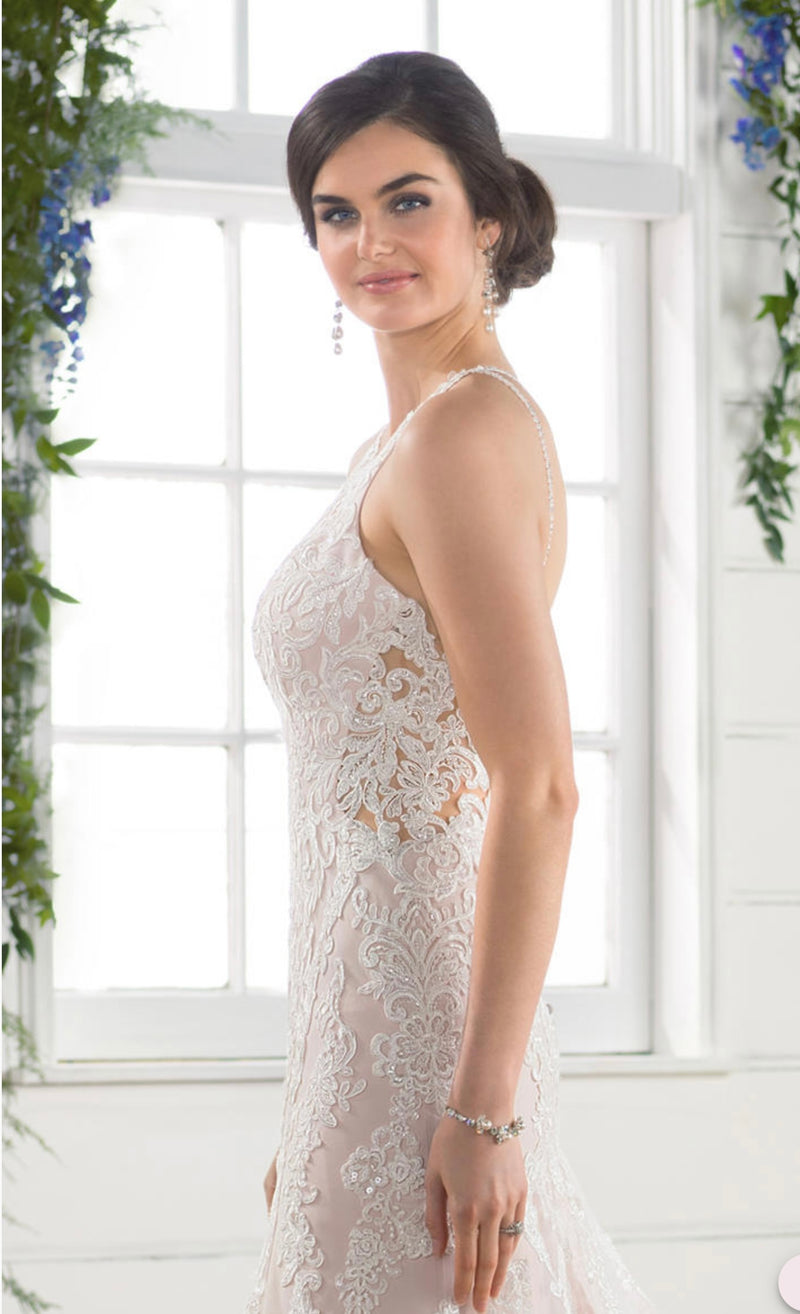 Essense of Australia D2432f featuring a high neckline, the bodice of this gown features peek-a-boo detailing with illusion tulle and a plunging sweetheart neckline. The rich lace pattern continues through the bodice and onto the tulle skirt, creating elongating, linear patterns