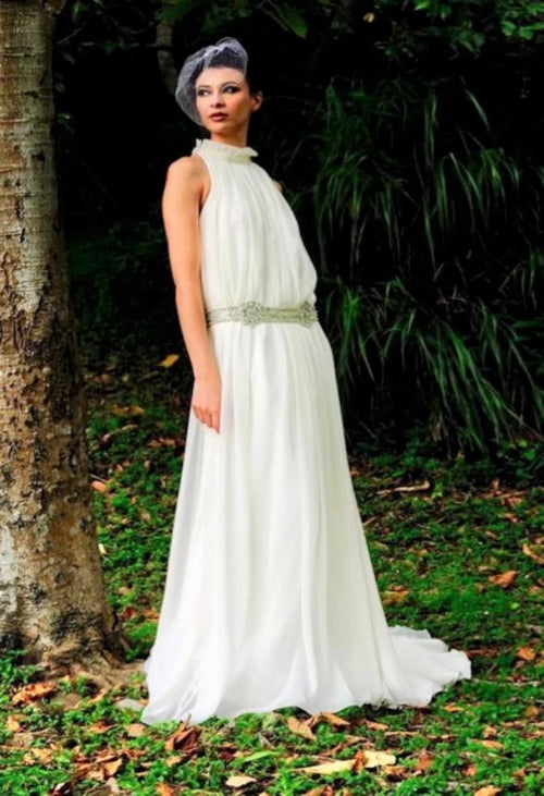 The unique Augusta Jones Olympia is a halter neck, sheath, chiffon bridal gown with a high back and chapel train