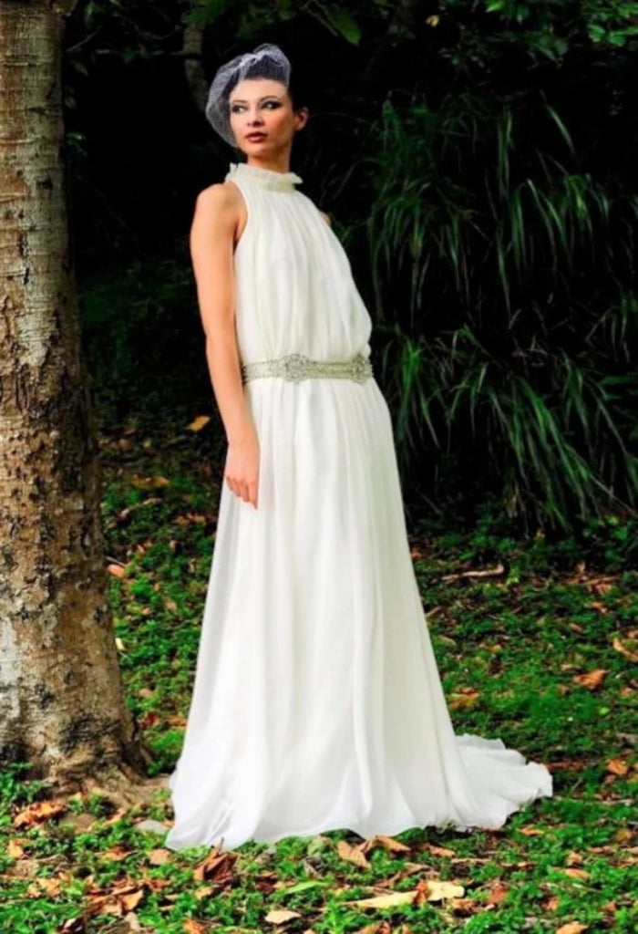 The unique Augusta Jones Olympia is a halter neck, sheath, chiffon bridal gown with a high back and chapel train