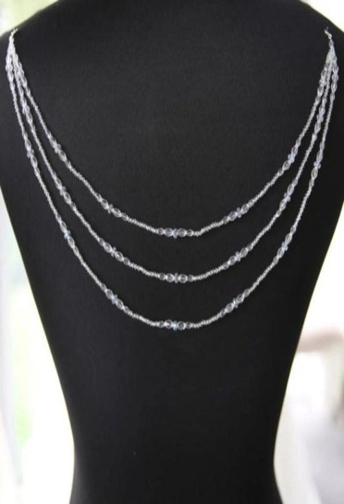 P672 is a stunning example of Pearl Crystal Dress Jewellery from Richard Designs. Three strands of sparkling crystal with a fastener on each side which attach to the back of a gown. Includes an extra loop so that this piece can be worn after the wedding as a necklace as well. Choice of Gold or Silver Findings