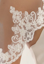 Bianco Evento Veil - S103 Single layered veil with lace edge Length 31 inch Lace adorned with hand attached beads Veil will be delivered with the comb already attached Designed and manufactured in Europe