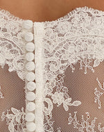 Bianco Evento Bolero E221 Beautiful bolero with delicate lace. With a Carmen Neck, 3/4 sleeves and elegant buttons for closing back. Carefully designed and manufactured within the EU.