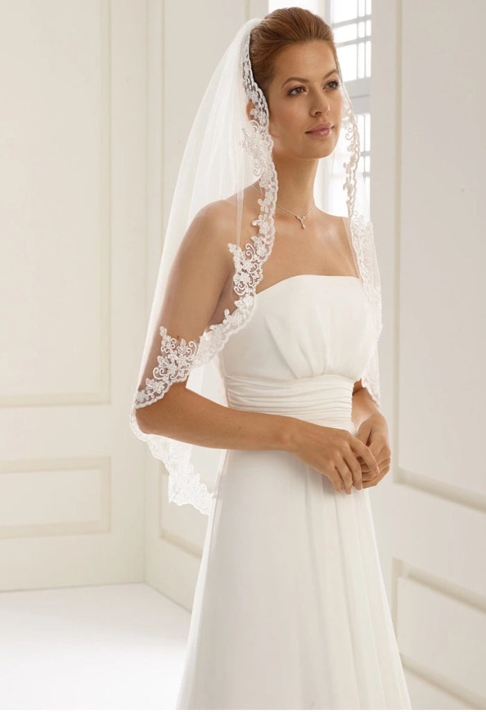 Bianco Evento Veil - S103 Single layered veil with lace edge Length 31 inch Lace adorned with hand attached beads Veil will be delivered with the comb already attached Designed and manufactured in Europe