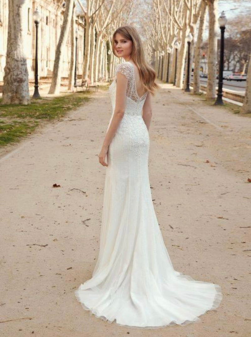 Fara Sposa 5670 gorgeous v-neck, beaded tulle wedding gown. Stunning fit and flare silhouette with an illusion v back and beautiful cap sleeves
