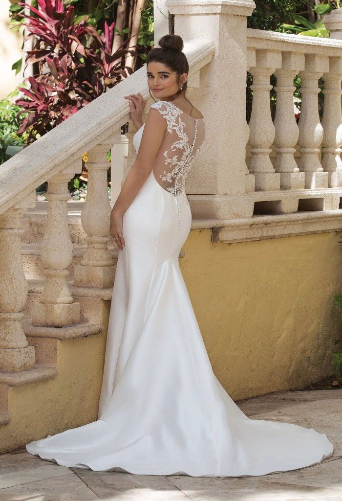 Stand out on your big day in Justin Alexander Sincerity Brides 44081, a mikado fit and flare gown. This dress features. beaded cap sleeves that lead to a low illusion back with beaded lace details. The baseball dart seaming on the bodice is the perfect final touch