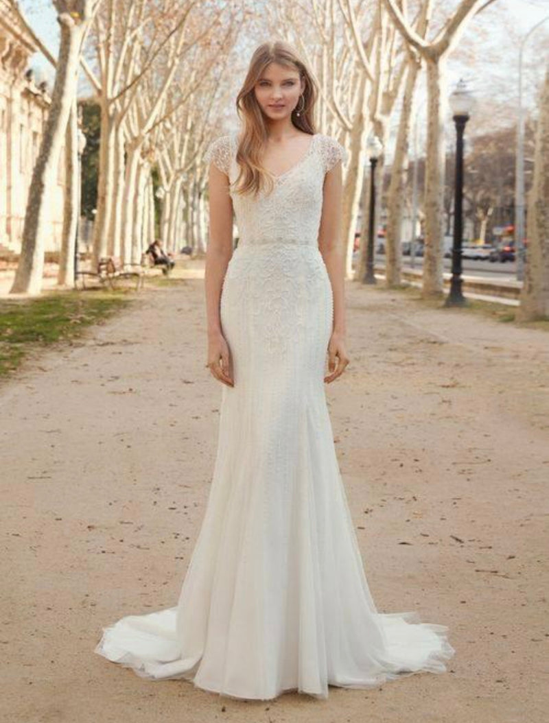 Fara Sposa 5670 gorgeous v-neck, beaded tulle wedding gown. Stunning fit and flare silhouette with an illusion v back and beautiful cap sleeves