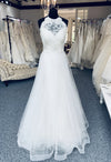 Tara Keely by Lazaro, style 2305 is a lace and tulle bridal gown with a lace halter neck. Size 8. New condition