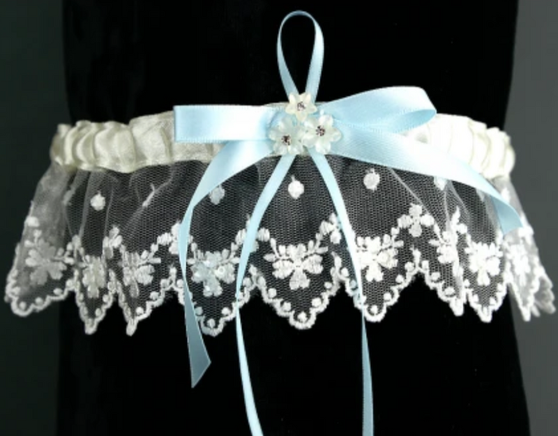 Garter TLG518 Ivory Lace garter with a blue ribbon. Flower and diamante centre