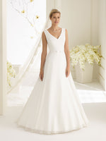 Bianco Evento Dalila is a simple a-line wedding dress, with a beautiful v-neckline and back. The dress is made from Chiffon and has a fine belt with a front bow brings the dress together.