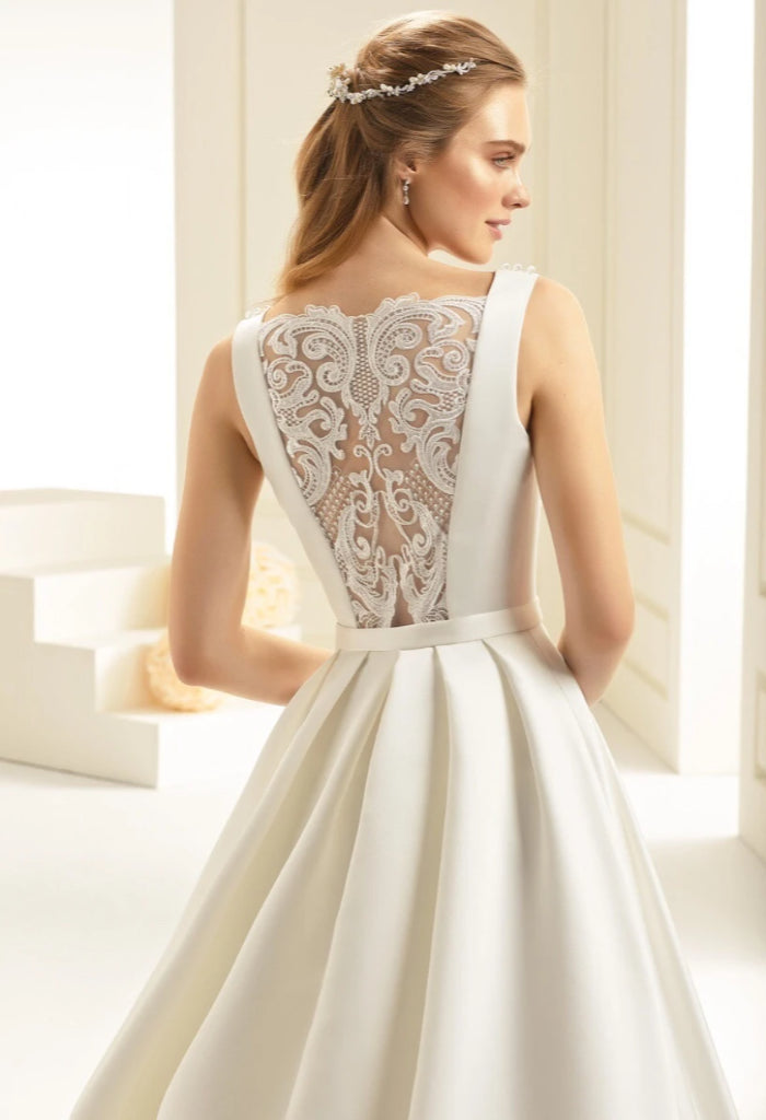 BIANC EVENTO CHIARA BIANC EVENTO CHIARA Bianco Evento Chiara, beautiful a-line silhouette, mikado and lace wedding gown with a round neckline. Stunning tattoo lace back design and chapel length train.