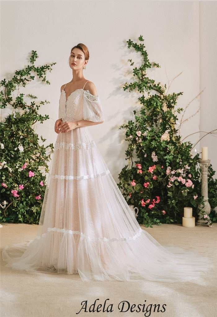 Adela Designs WD2056, beautiful flutter sleeve, blush wedding dress with a sweetheart neckline . Made of soft tulle and chantilly lace, with a deep v back.