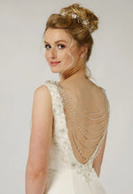 Richard Designs Multi-Strand Dress Jewellery P836 is a seven stranded pearls and crystal back jewellery gathered at the shoulders with hand beaded lace flowers. Simply secure to your gown with the clasps at each end.