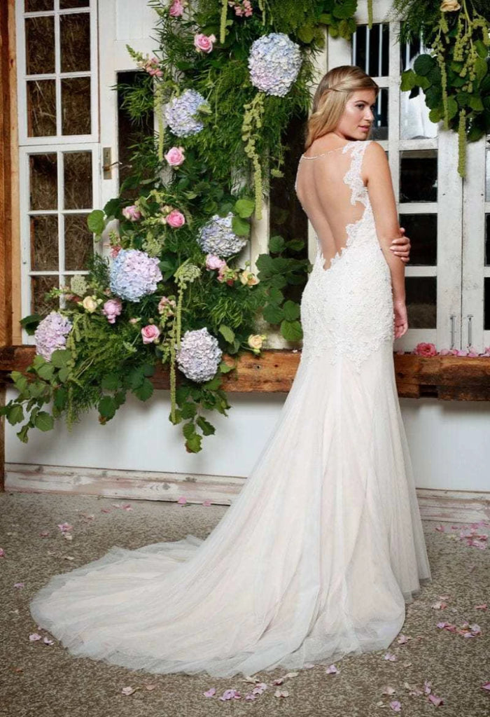 Stunning Amanda Wyatt Paola is a fit and flare silhouette, lace and tulle wedding gown with beaded detailing. This dress boasts a gorgeous, open illusion back and a chapel length train.